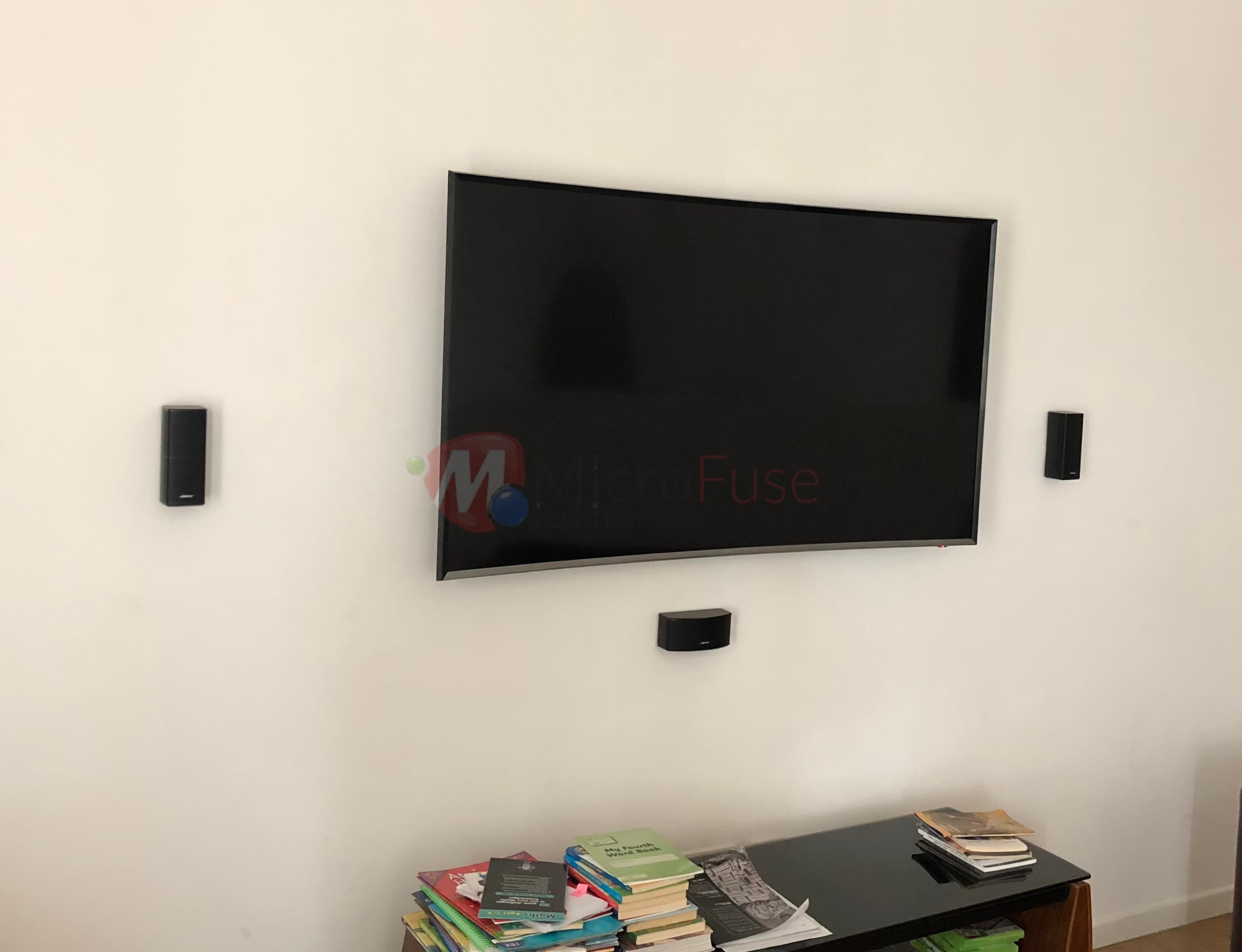 Wall-mounted display with in-ceiling audio